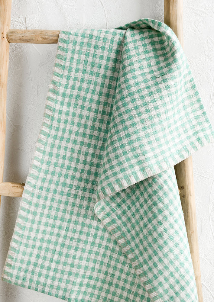 A woven gingham linen tea towel in spearmint color.