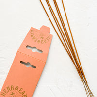 3: Long, skinny sticks of dipped incense on bamboo sticks.