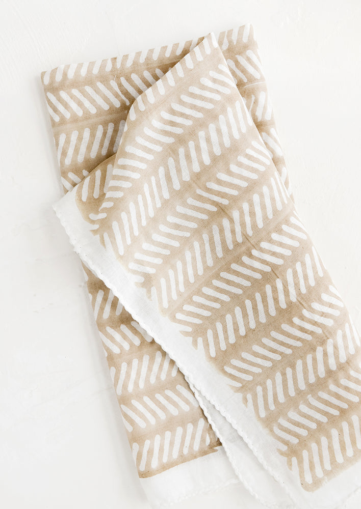 1: Lightweight cloth napkin with beige background and white herringbone block print pattern