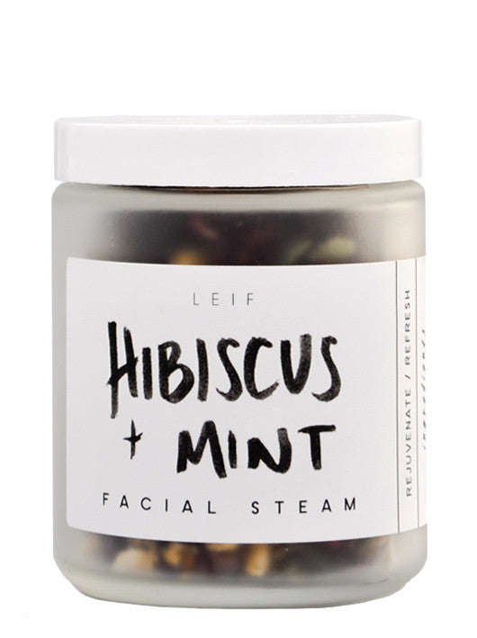 Hibiscus + Mint: A frosted glass jar with a black and white label and white plastic lid.