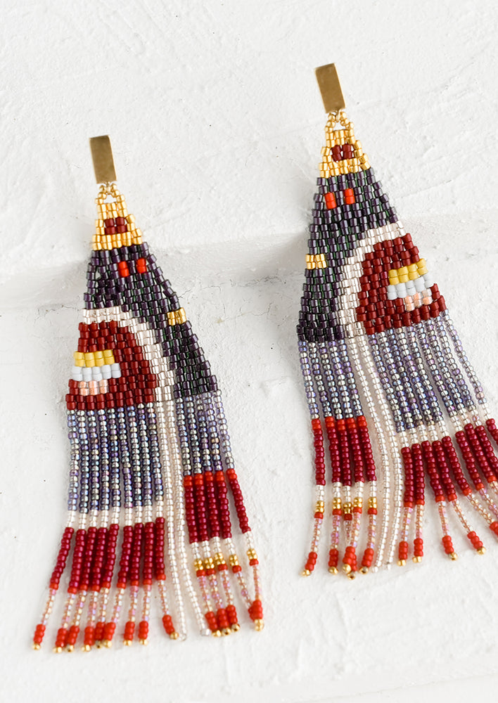 A pair of beaded earrings in red and blue geometric design with brass posts.