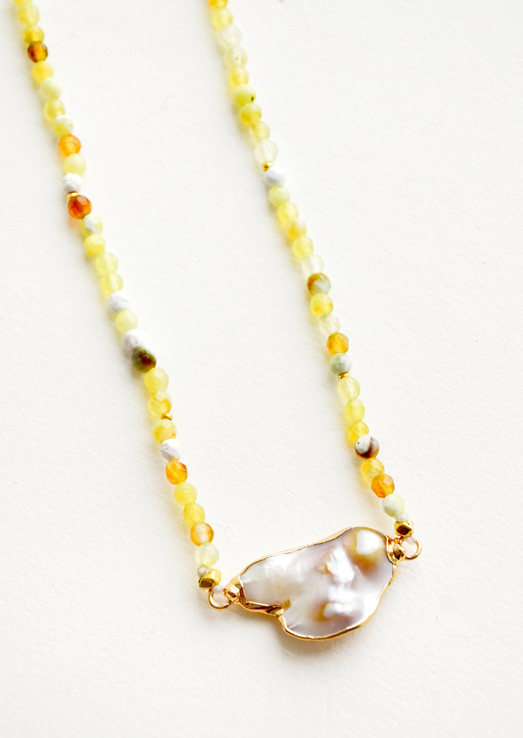 2: Gemstone beaded necklace in shades of yellow with asymmetrical grey pearl pendant at front