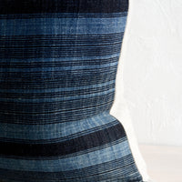 3: Indigo fabric with variegated black stripes.