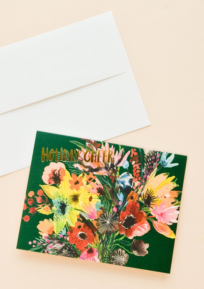 Greeting card with elaborate, colorful floral bouquet with "Holiday cheer" printed in gold letters. Shown with white envelope.