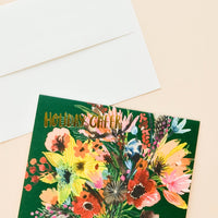 1: Greeting card with elaborate, colorful floral bouquet with "Holiday cheer" printed in gold letters. Shown with white envelope.