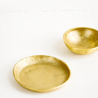 1: Small brass bowl and plate, both showing an organic, textured finish