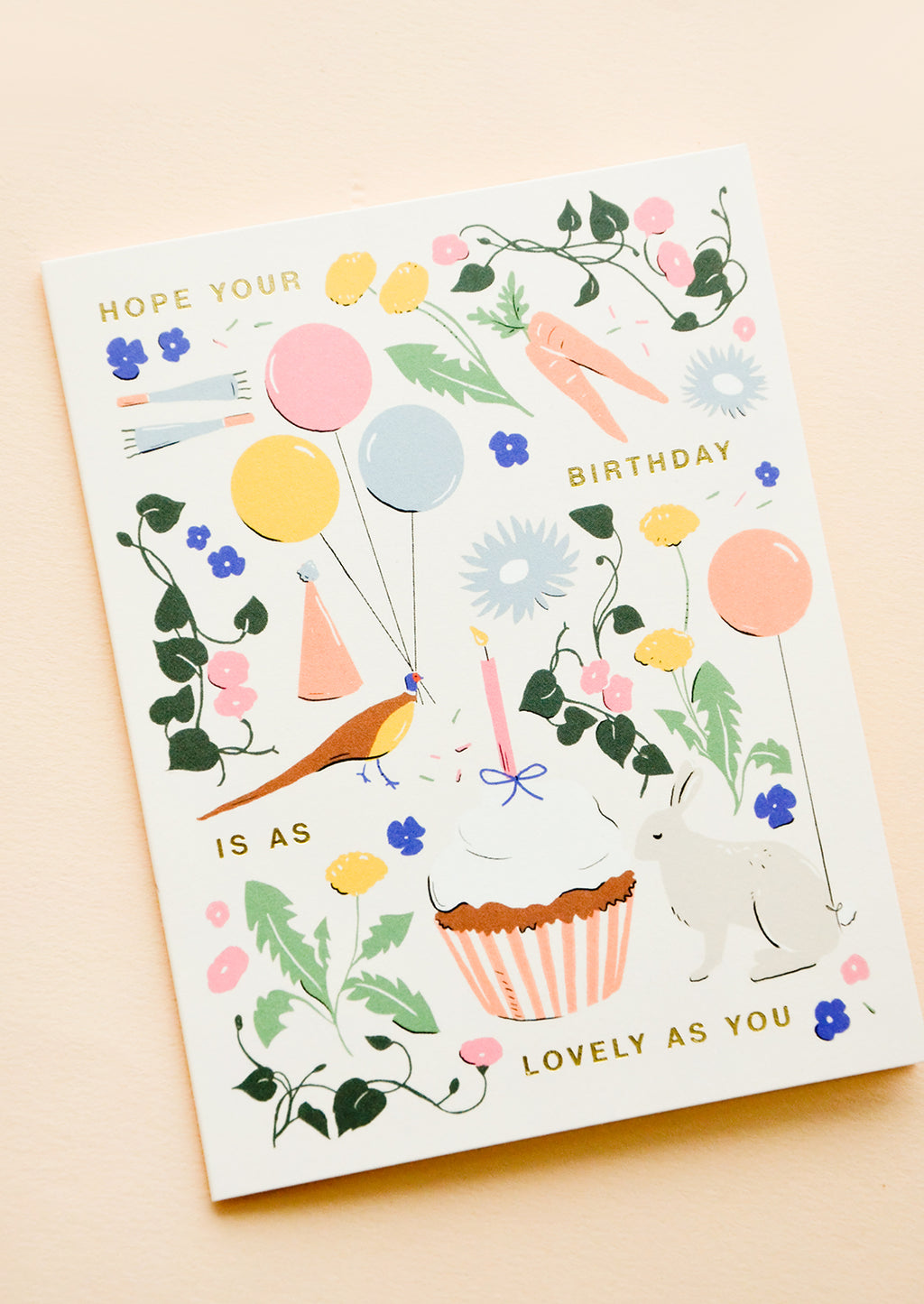 1: Whimsically illustrated greeting card with garden-centric scene and golden lettering reading "Hope your birthday is as lovely as you"