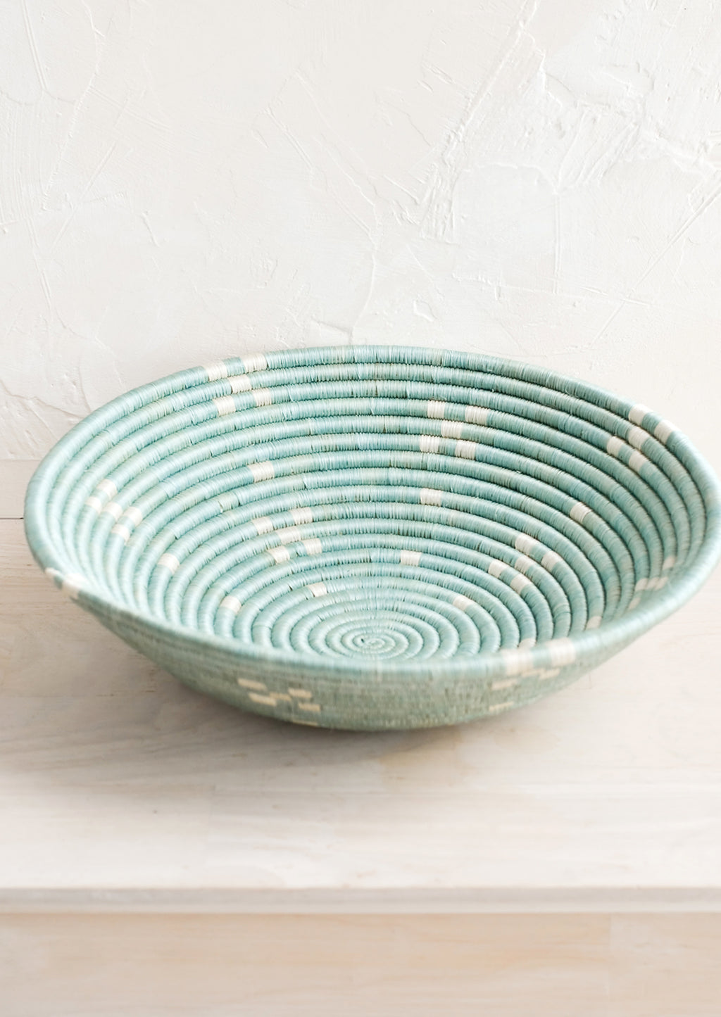 Lake Blue: A round sweetgrass bowl in blue with white pattern.