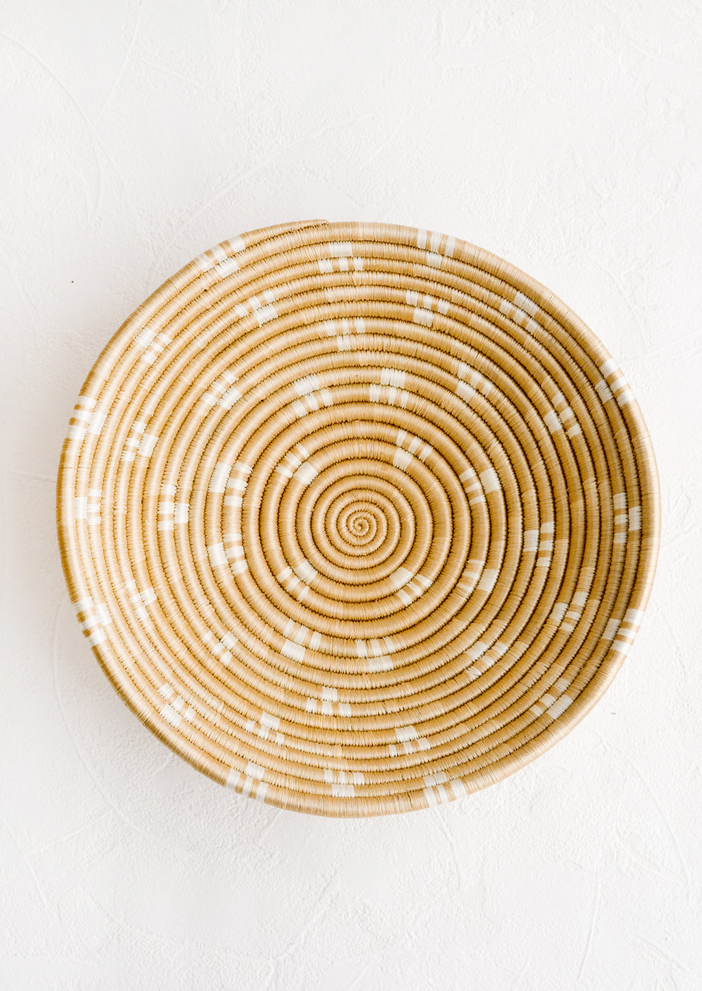 Toasted Almond: A round sweetgrass bowl in tan with white pattern.