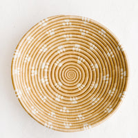 Toasted Almond: A round sweetgrass bowl in tan with white pattern.