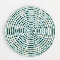 Lake Blue: A round sweetgrass trivet in blue with white dash pattern.