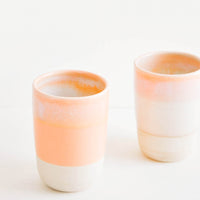 Sunset Dip: Two ceramic tumblers with unfinished bottoms and orange glaze.