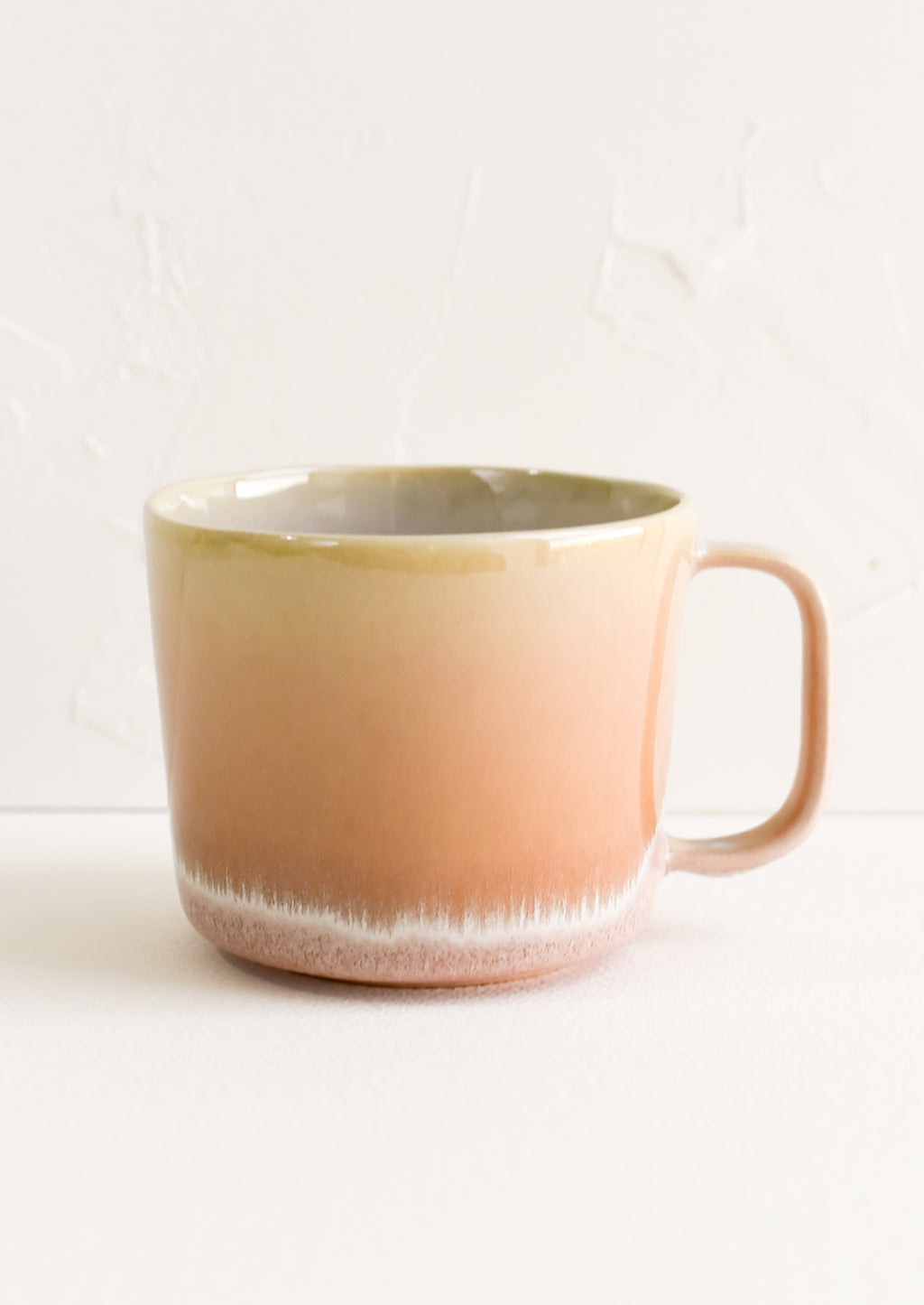 Dawn: A ceramic mug in peach with ombre glaze.