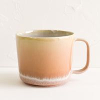 Dawn: A ceramic mug in peach with ombre glaze.