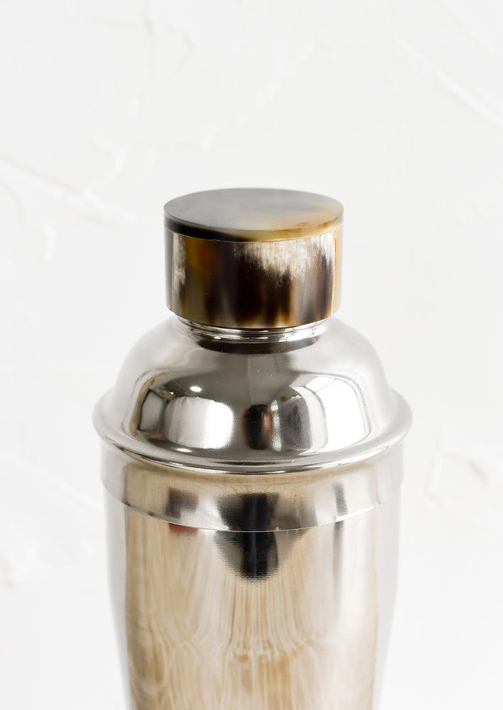 2: A stainless steel cocktail shaker with horn cap.