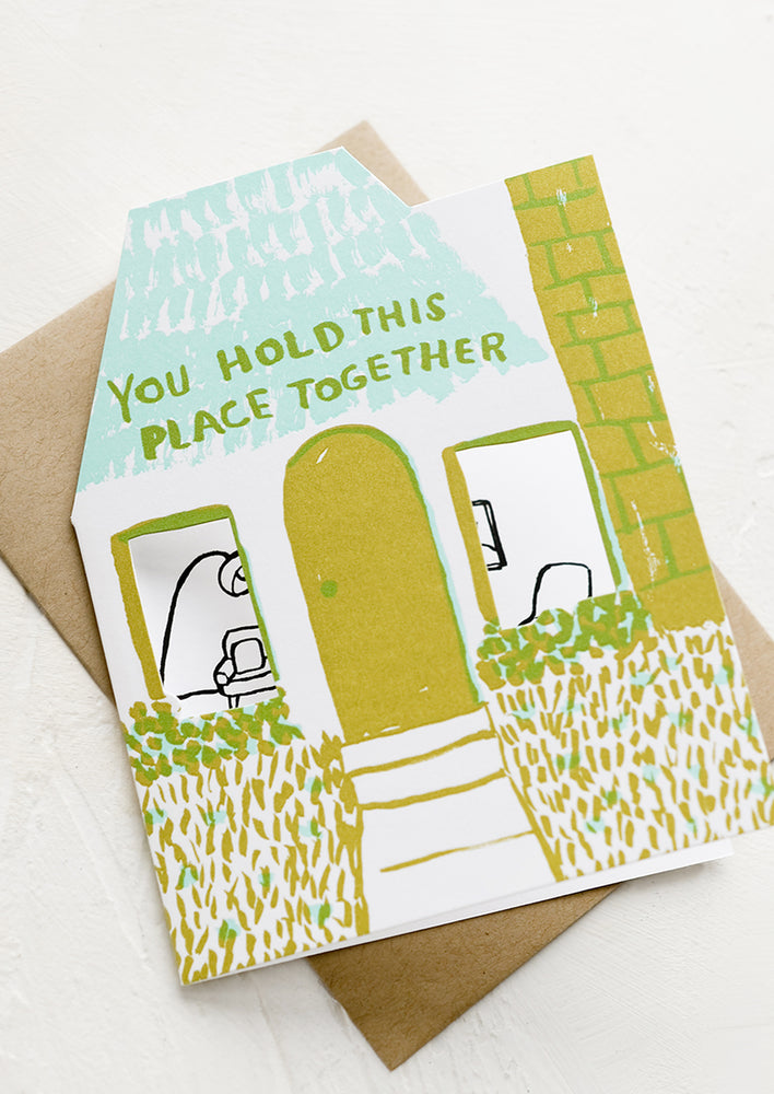 A house die cut shaped card reading "You hold this place together".