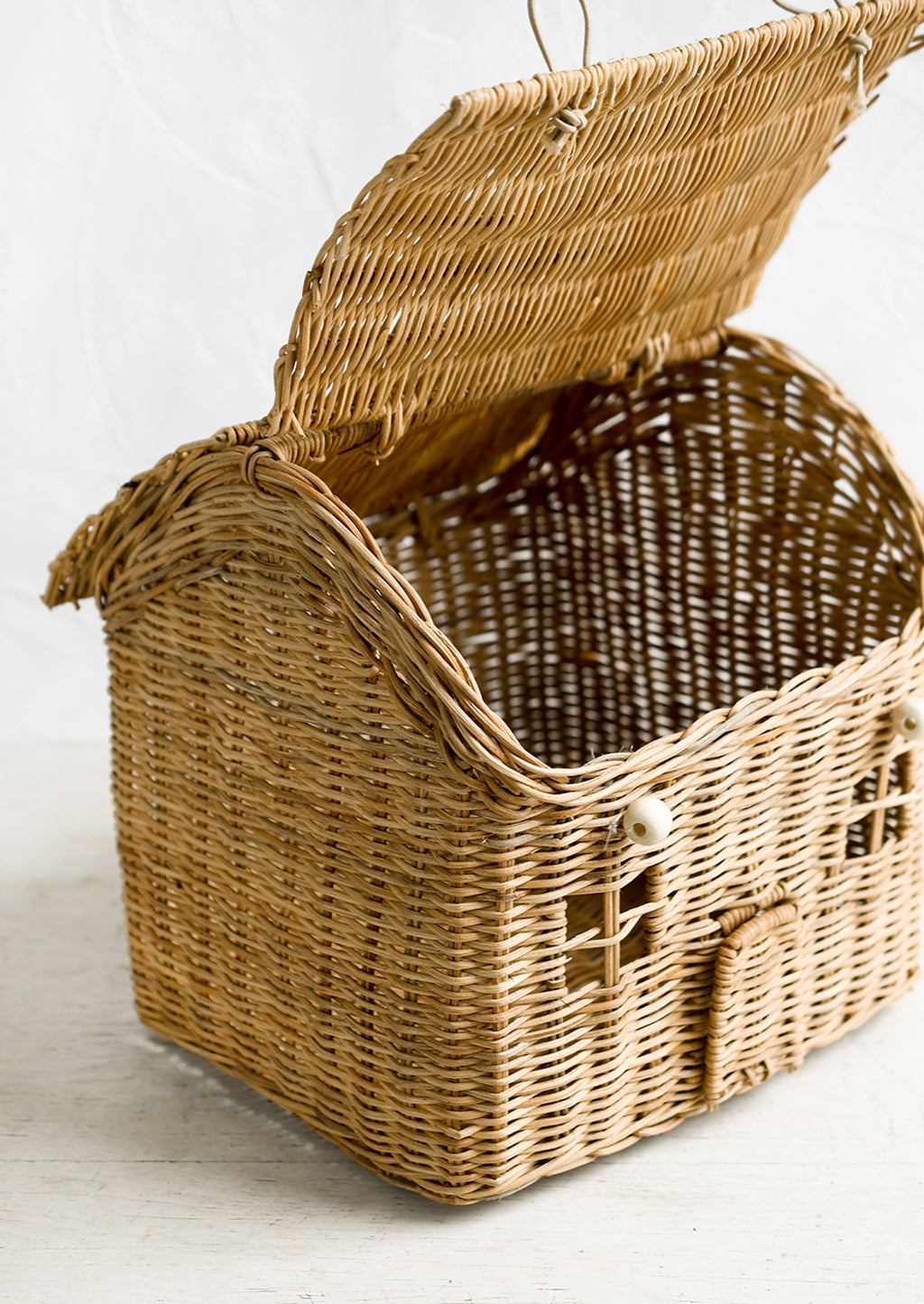 3: A rattan storage basket in the shape of a house.