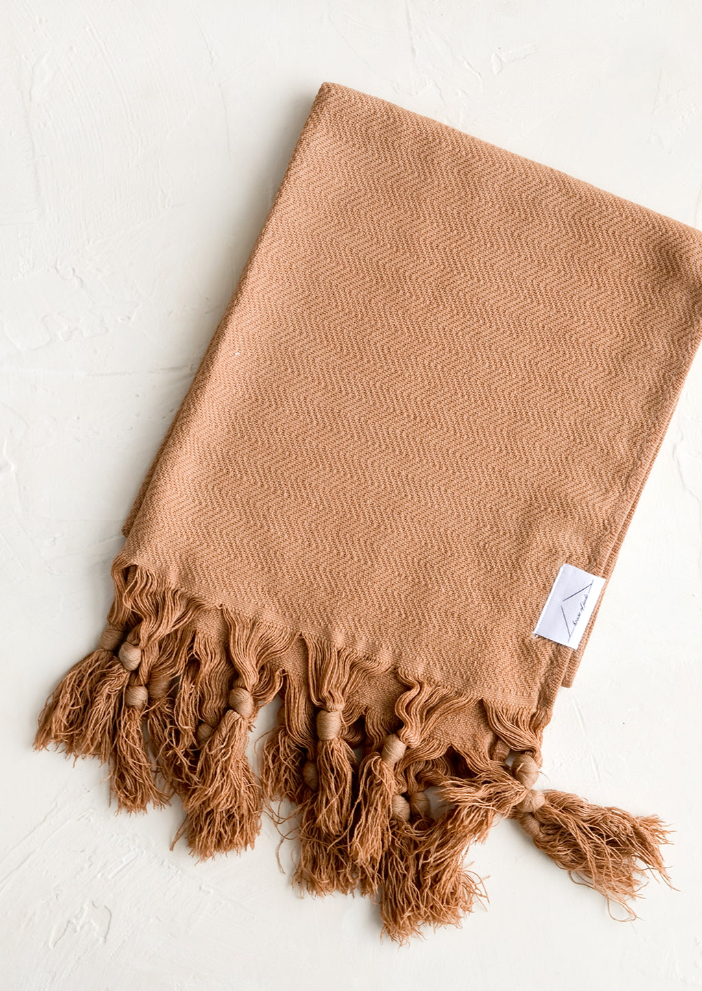 Milk Chocolate: A turkish hand towel in chocolate brown with tonal fringed trim.