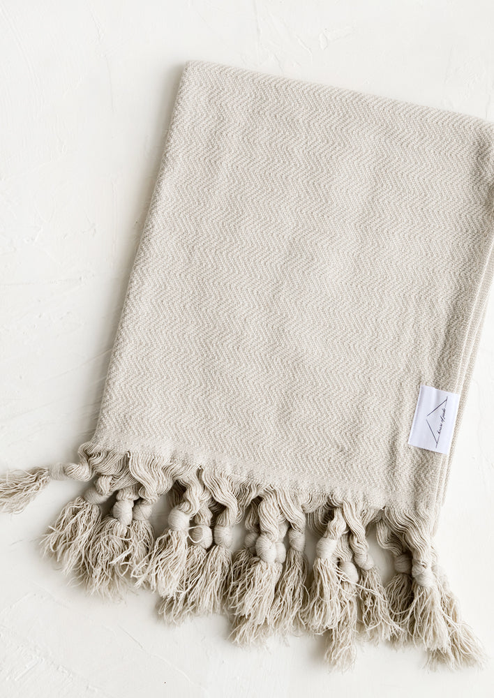 Oyster: A turkish hand towel in warm oyster grey hue with tonal fringed trim.