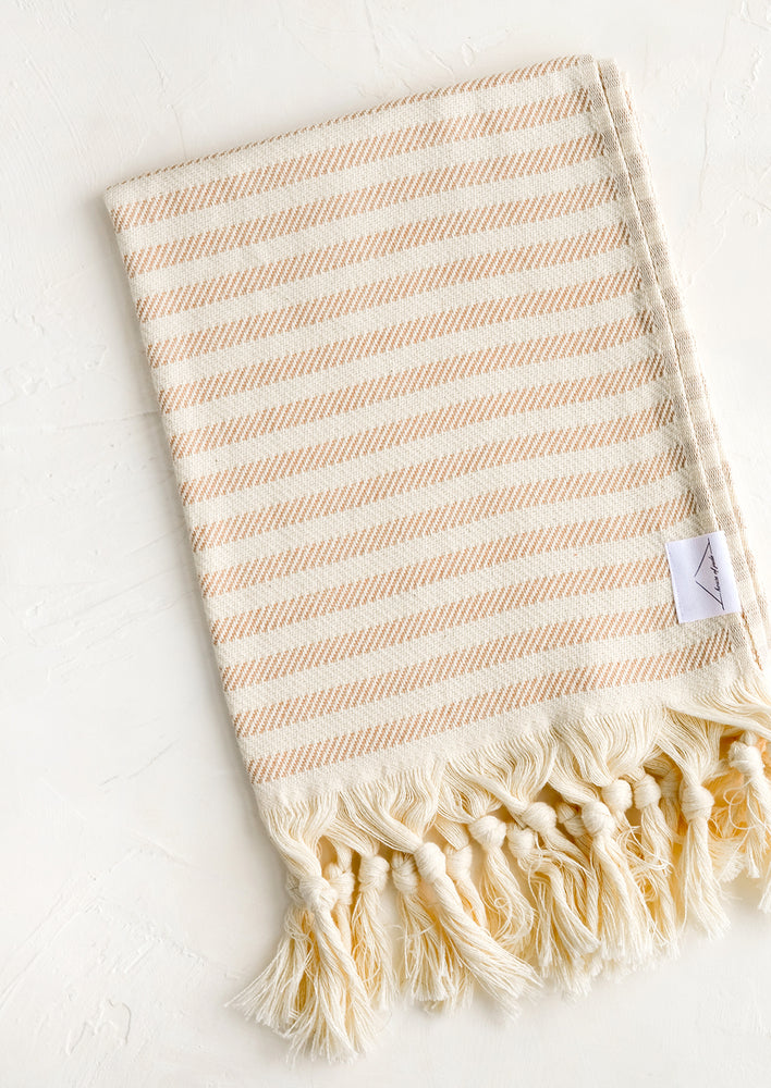 Tan Stripe: A turkish hand towel in natural with tan stripes with natural fringed trim.
