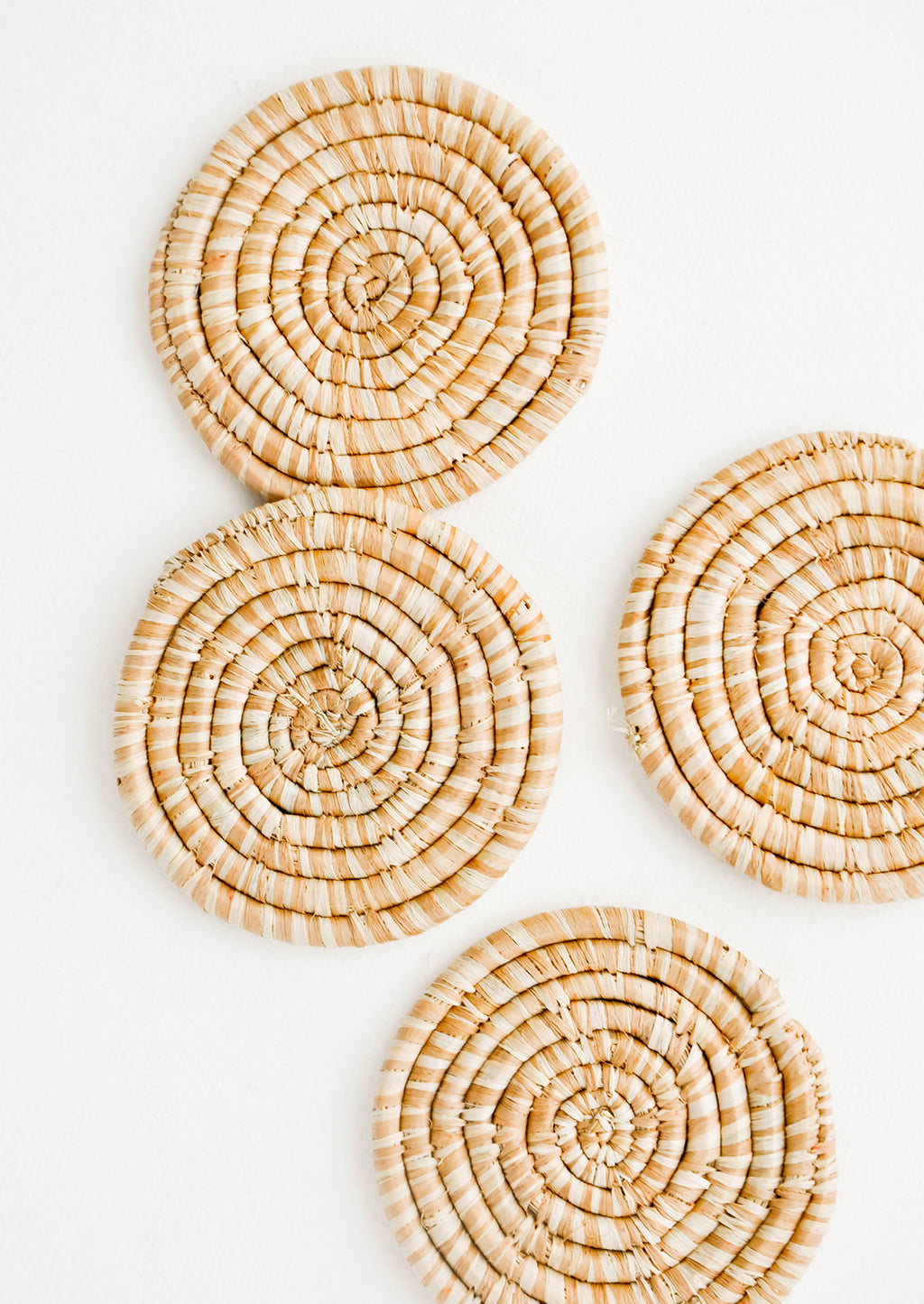 Tan: Set of 4 Round Woven Raffia Coasters in Tan and natural stripe.