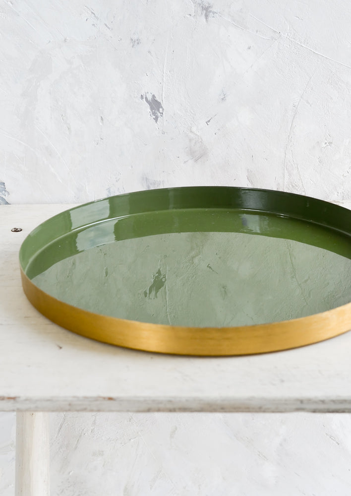 Olive Green: A large, round enamel tray with shallow brass rim and green interior.