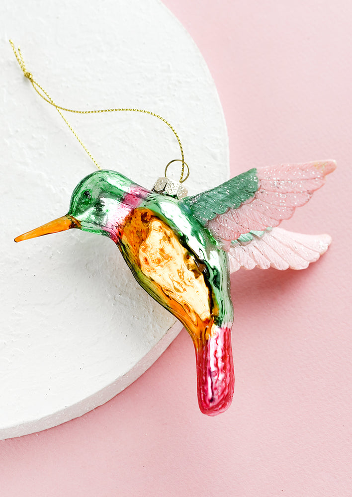 A glass holiday ornament of a hummingbird.