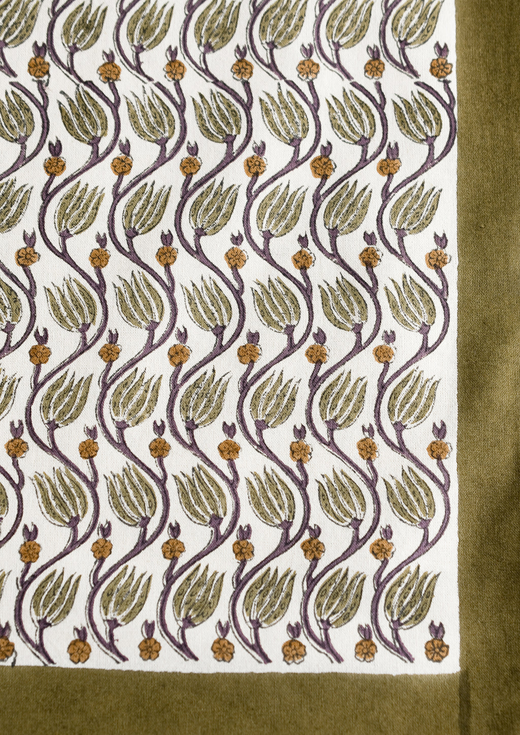 3: A botanical print tablecloth with olive green trim.