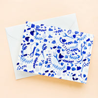 2: A greeting card with white and blue watercolor floral print, paired with light blue envelope.
