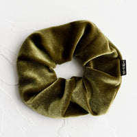 Olive: A velvet scrunchie in olive green with logo tag.