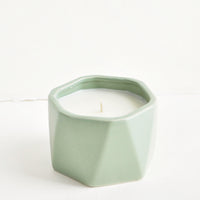 Santal Fig: A small candle in green faceted ceramic vessel.