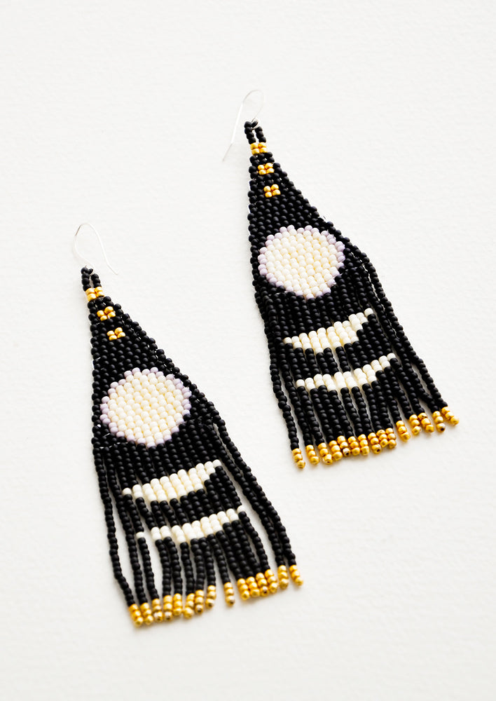 1: Dangling earrings with black and white geometric beaded shapes and black and gold beaded fringe.
