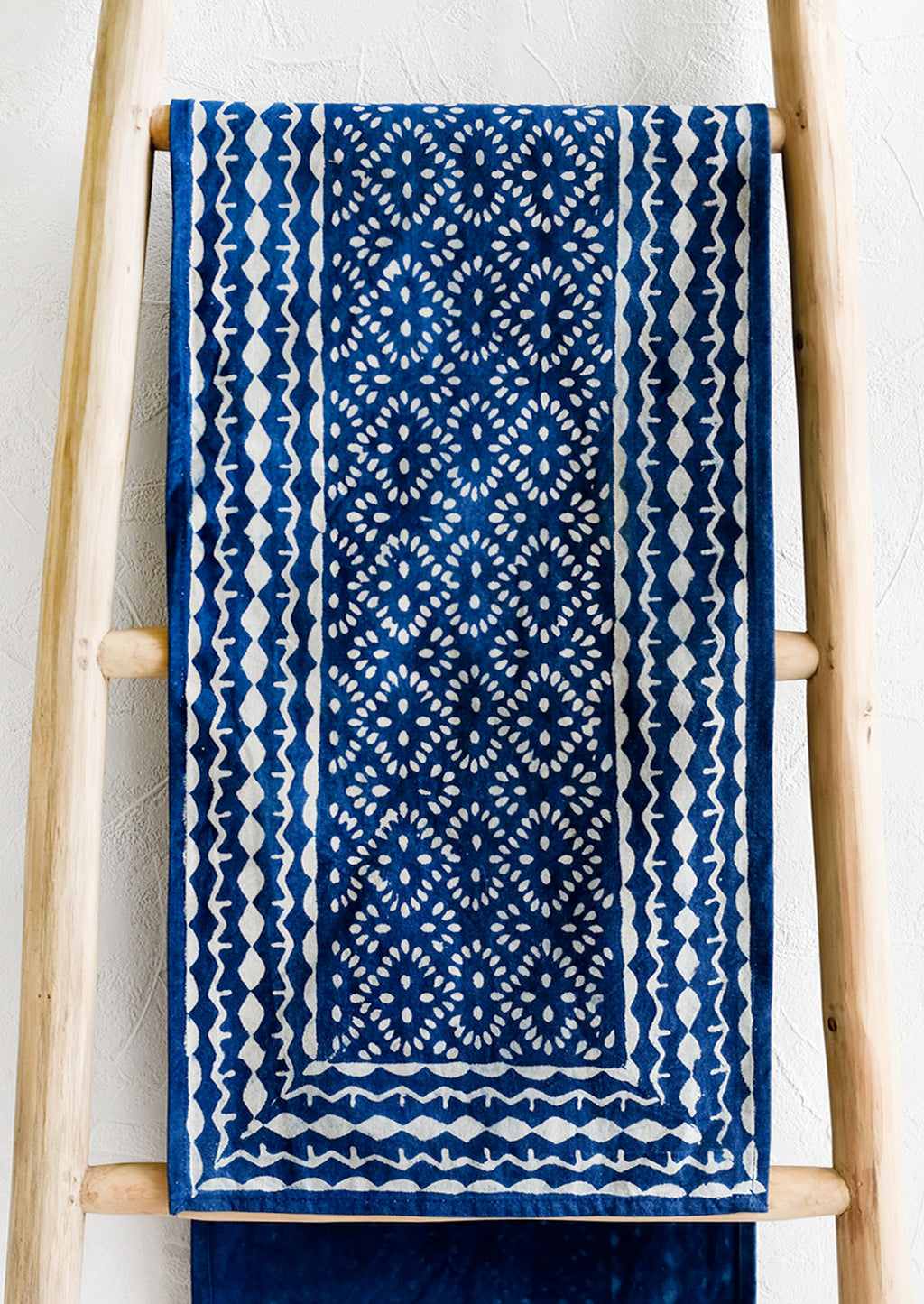 1: An indigo cotton table runner with block printed design.