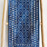 1: An indigo cotton table runner with block printed design.