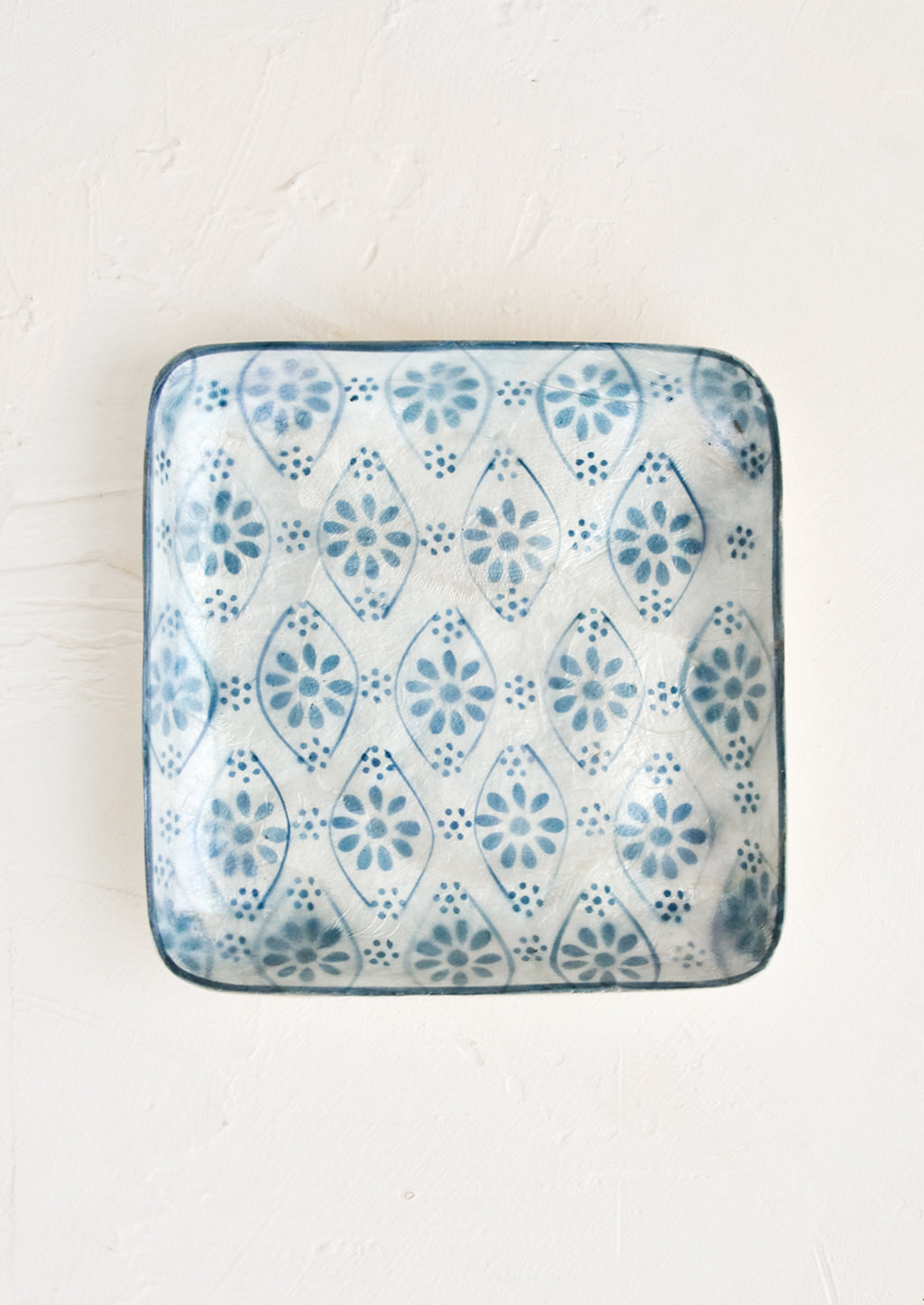 Floral Motif: A small square catchall tray in indigo motif.