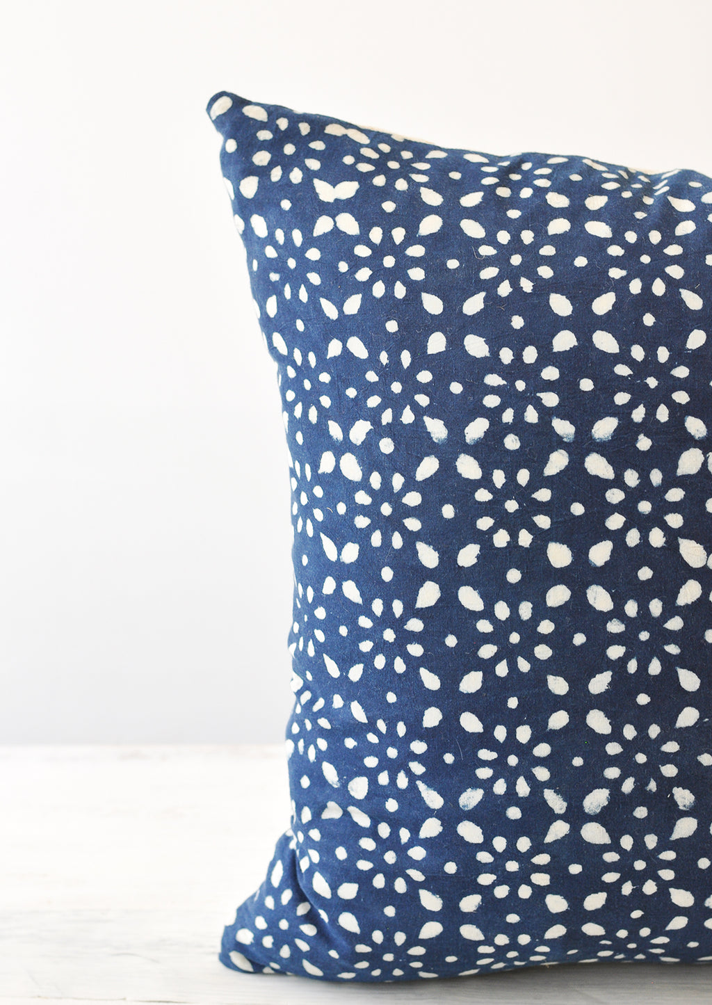 2: A detail shot of a square indigo and white block printed pillow.