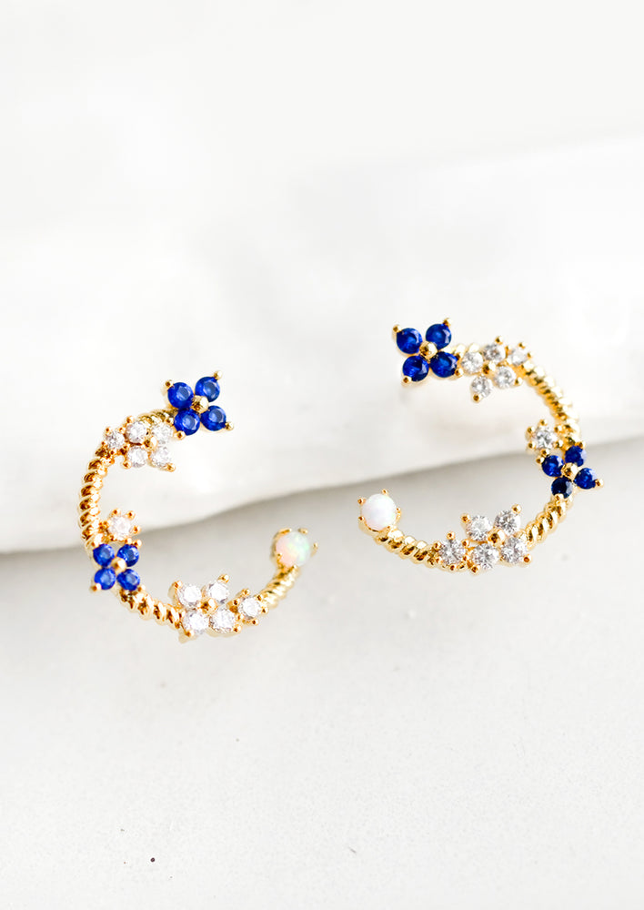 1: Gold hoop stud earrings with floral crystal detailing.