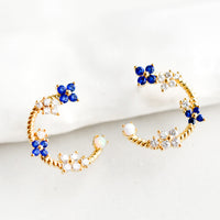 1: Gold hoop stud earrings with floral crystal detailing.