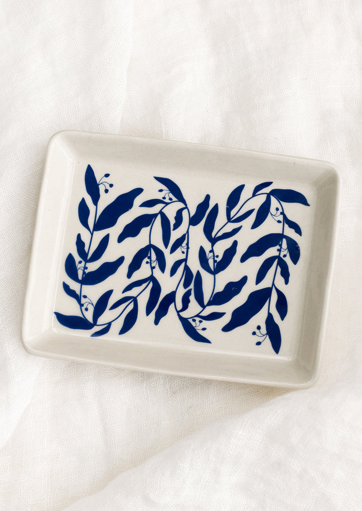 Large: A rectangular white ceramic tray with allover blue leaf pattern.