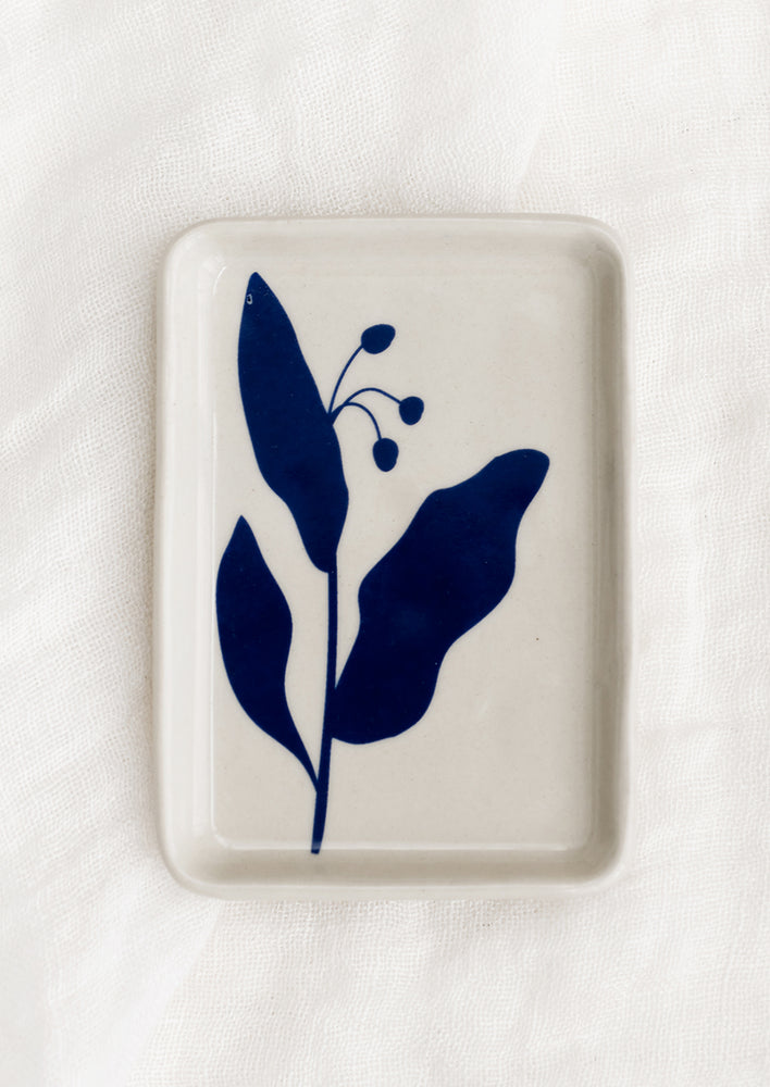 A white ceramic tay with blue floral print.