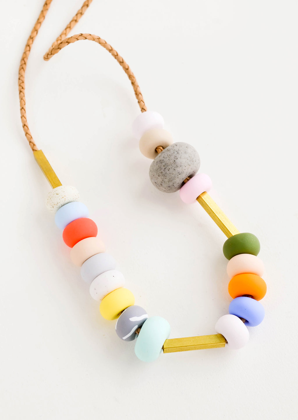 2: Round clay beads in a mix of colors, textures and sizes strung on leather cord