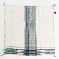 2: A khadi cotton napkin with tassel detailing.