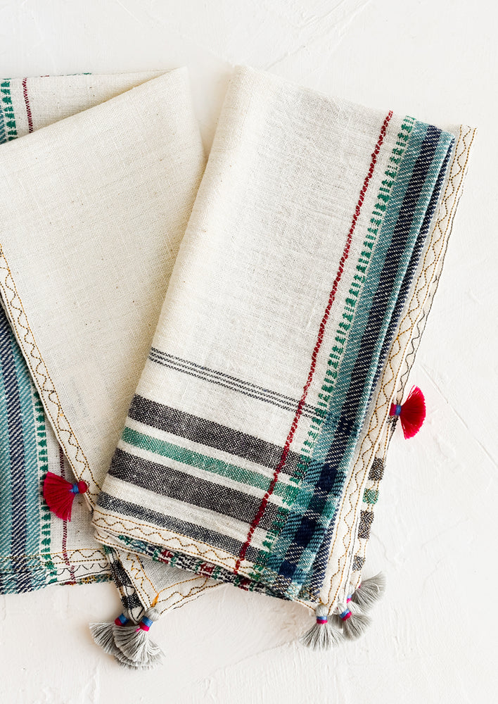 A pair of khadi cotton napkins with tassel detailing.