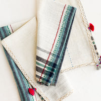 1: A pair of khadi cotton napkins with tassel detailing.