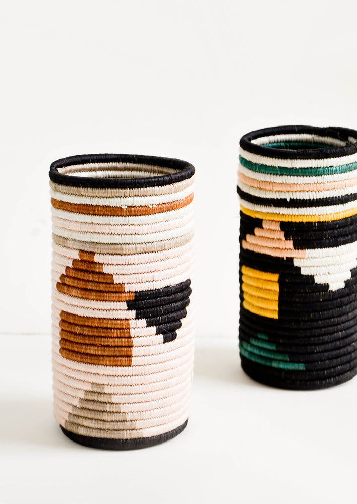 Tall vases made of woven natural grass in colorful geometric pattern