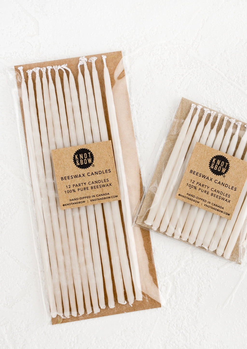 Short / Ivory: Two packages of ivory beeswax birthday candles in short and long lengths.