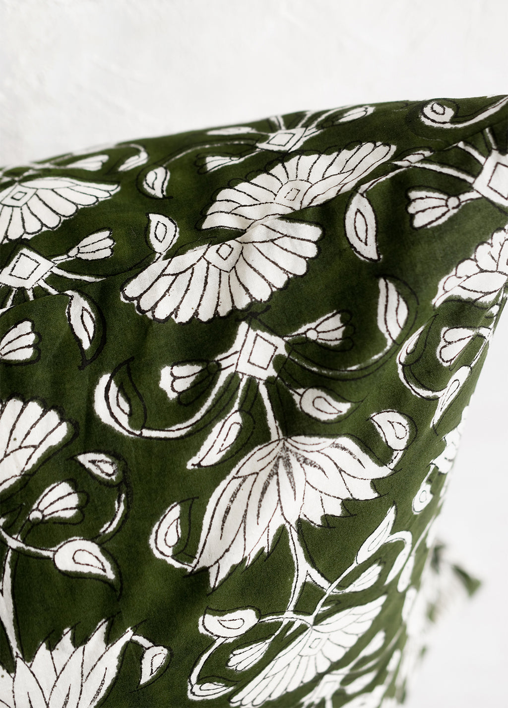 3: A block printed pillow in green and ivory floral motif.
