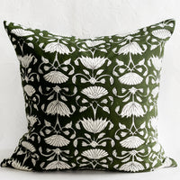 1: A block printed pillow in green and ivory floral motif.