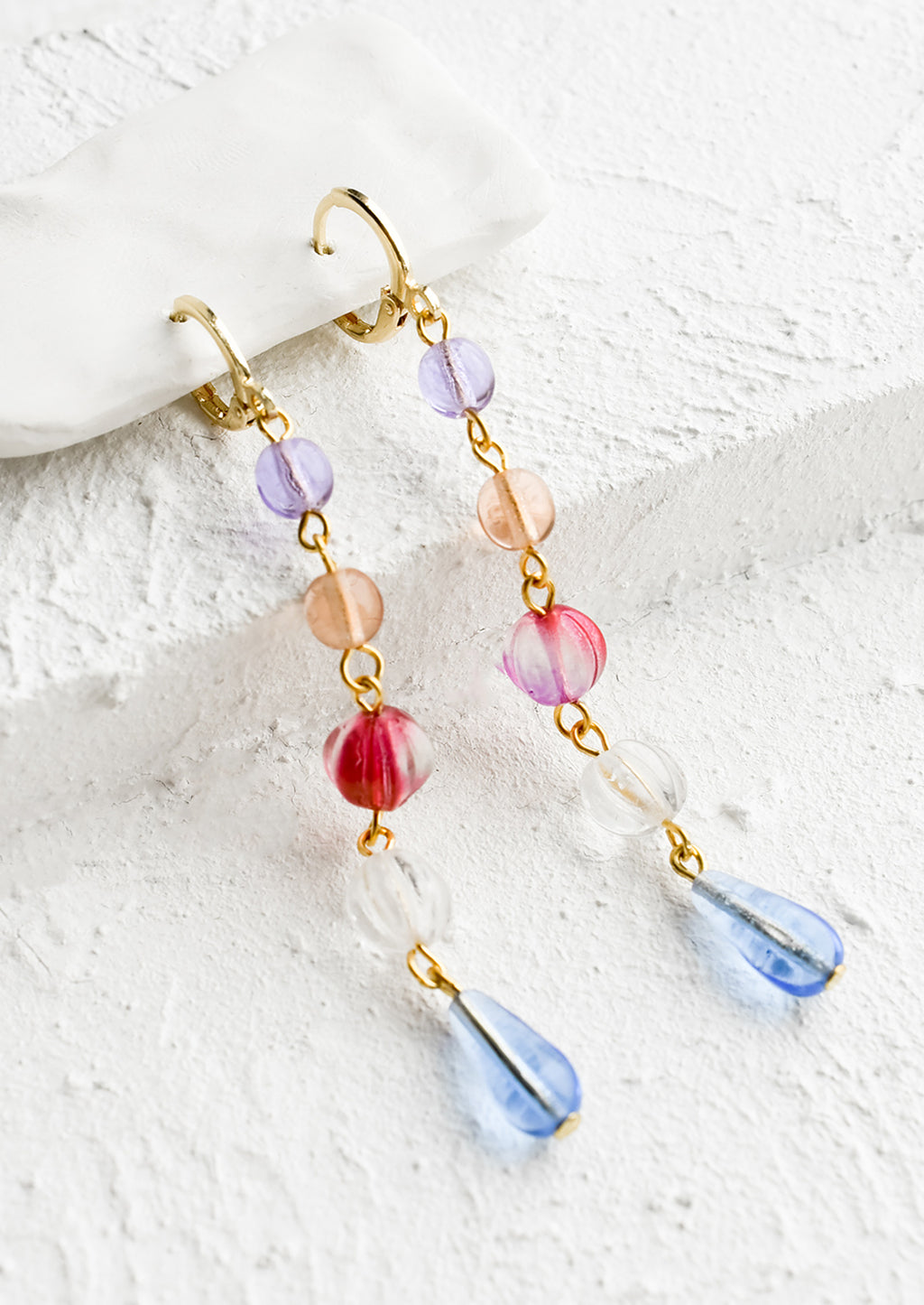 Blue Multi: A pair of drop earrings with a beaded strand of colored glass beads with pearl detailing.