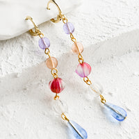 Blue Multi: A pair of drop earrings with a beaded strand of colored glass beads with pearl detailing.